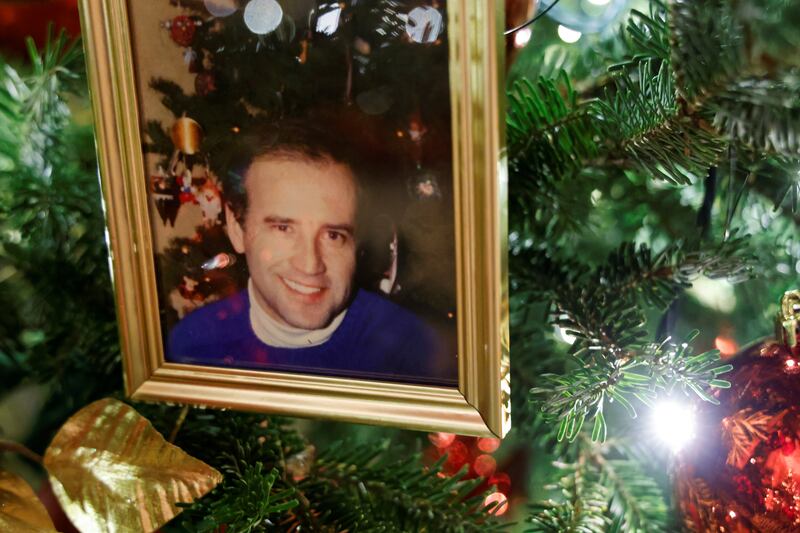 Christmas trees in the State Dining Room are decorated with snapshots of US presidents and their families. This photo shows a younger President Joe Biden. Reuters