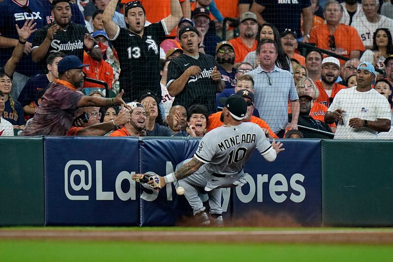 Chicago White Sox's Yoan Moncada crashes into a wall as he tries to field a foul ball hit by Houston Astros' Yordan Alvarez during the MLB game on Friday, October  8. AP