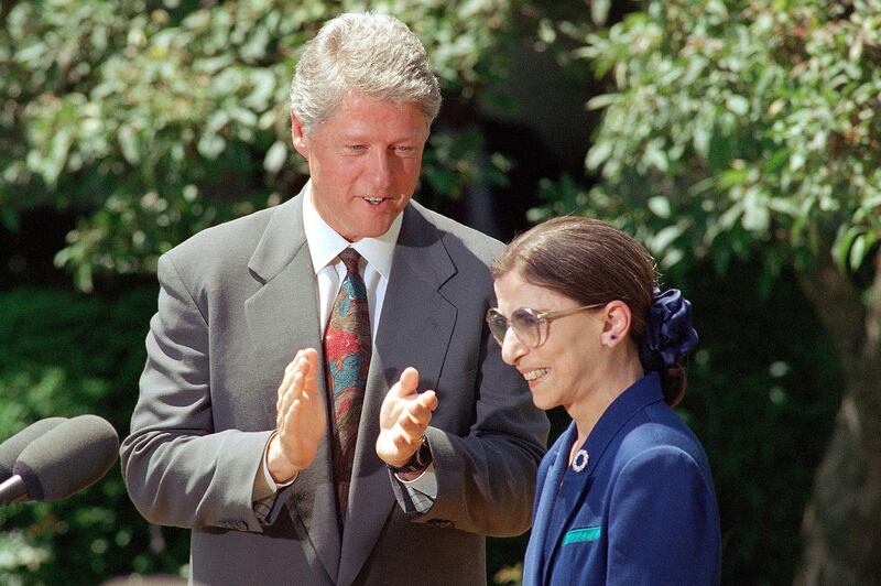 In this June 15, 1993, file photo, President Bill Clinton applauds as Judge Ruth Bader Ginsburg prepares to speak in the Rose Garden of the White House,after the president announced he would nominate Ginsburg to the Supreme Court. AP