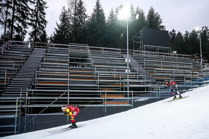 The cornavirus outbeak leaves Thierry Langer, left, of Belgium and the American Leif Nordgren competing in front of empty stands due during the men's 4x7.5km relay race at the IBU Biathlon World Cup in Nove Mesto na Morave, Czech Republic, on Saturday, March 7. EPA