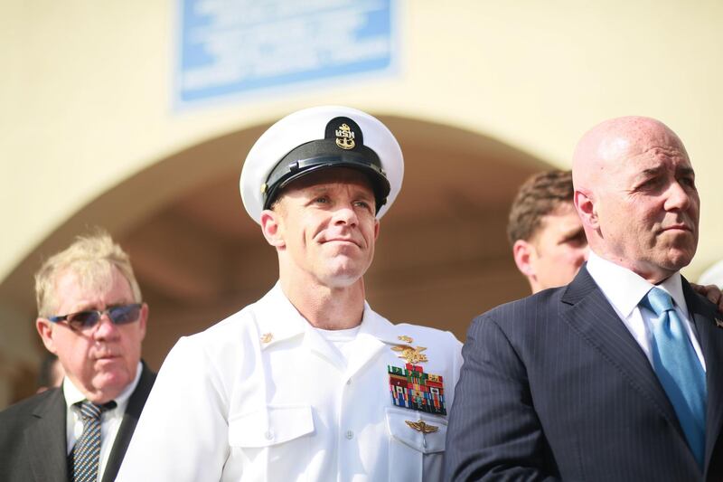 SAN DIEGO, CA - JULY 02:R, Navy Special Operations Chief Edward Gallagher celebrates after being acquitted of premeditated murder at Naval Base San Diego July 2, 2019 in San Diego, California. Gallagher was found not guilty in the killing of a wounded Islamic State captive in Iraq in 2017. He was cleared of all charges but one of posing for photos with the dead body of the captive.   Sandy Huffaker/Getty Images/AFP