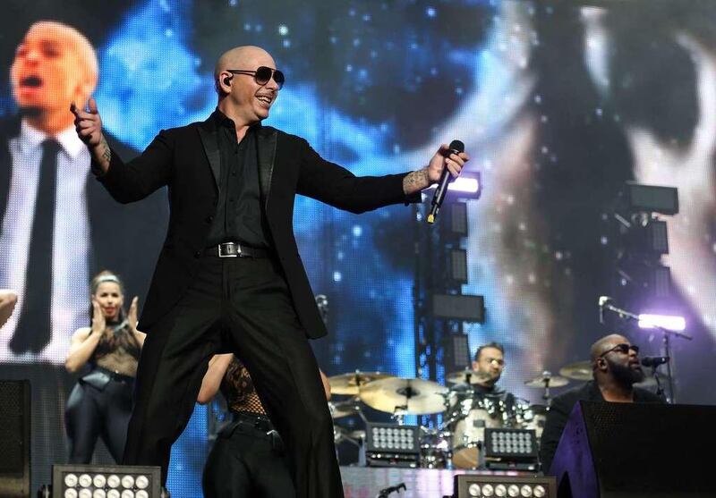 Mirroring the lyrics or his songs, Pitbull surrounds himself with images of sharp suits, glamorous females, fast cars and gleaming cityscapes on stage at the Du Arena on November 24, 2016, at the first 2016 Abu Dhabi Grand Prix after-race concert.