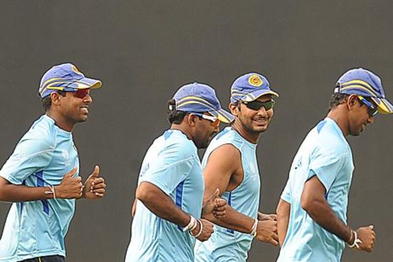 Kumar Sangakkara, second from right, the Sri Lanka captain, warms up with his teammates at R Premadasa Stadium in Colombo on Thursday. Sangakkara expects to shoulder his nation's expectations when they take on England in the quarter-finals today.