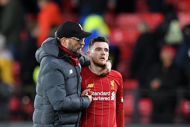 Liverpool's German manager Jurgen Klopp (L) and Liverpool's Scottish defender Andrew Robertson react at the final whistle during the English Premier League football match between Watford and Liverpool at Vicarage Road Stadium in Watford, north of London on February 29, 2020. RESTRICTED TO EDITORIAL USE. No use with unauthorized audio, video, data, fixture lists, club/league logos or 'live' services. Online in-match use limited to 120 images. An additional 40 images may be used in extra time. No video emulation. Social media in-match use limited to 120 images. An additional 40 images may be used in extra time. No use in betting publications, games or single club/league/player publications. / AFP / Justin TALLIS / RESTRICTED TO EDITORIAL USE. No use with unauthorized audio, video, data, fixture lists, club/league logos or 'live' services. Online in-match use limited to 120 images. An additional 40 images may be used in extra time. No video emulation. Social media in-match use limited to 120 images. An additional 40 images may be used in extra time. No use in betting publications, games or single club/league/player publications.