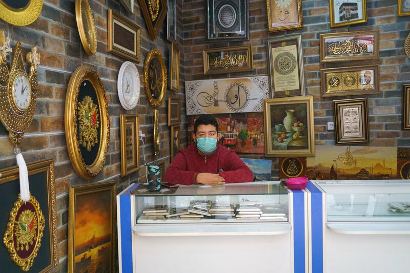 Mehmet (16) years old student works in his father's 25 years old store in Kucukpazar, Istanbul.
Due to restrictions on schools, he can take his online classes in the store and help his father. Kucukpazar, Istanbul,Turkey 2021.