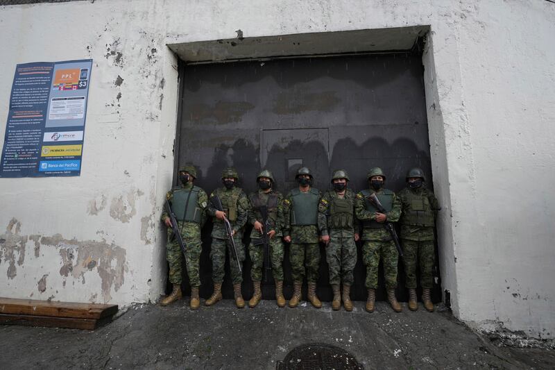 Soldiers on guard at the Inca jail where eight inmates were killed during a prison riot in Quito, Ecuador. AP