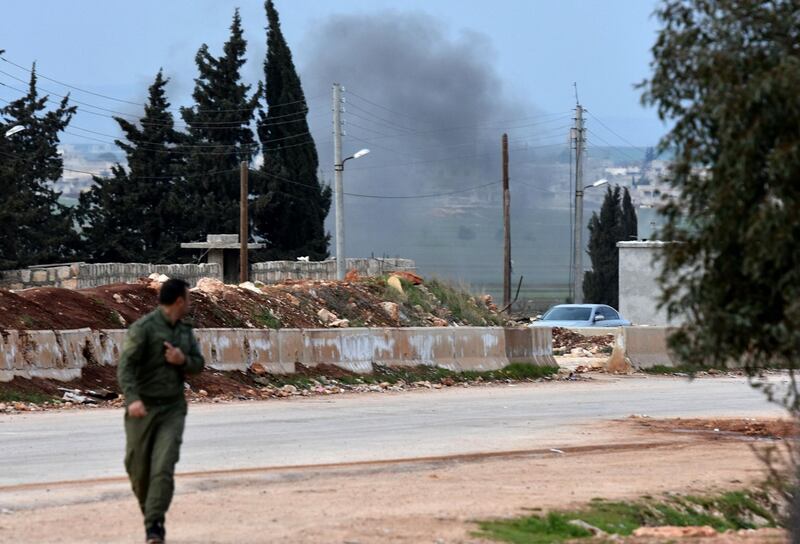 A Kurdish fighter evacuating following Turkish artillery bombardment near the Afrin crossing in the northern Syrian region, after Syrian pro-government forces entered the region. George Ourfalian / AFP