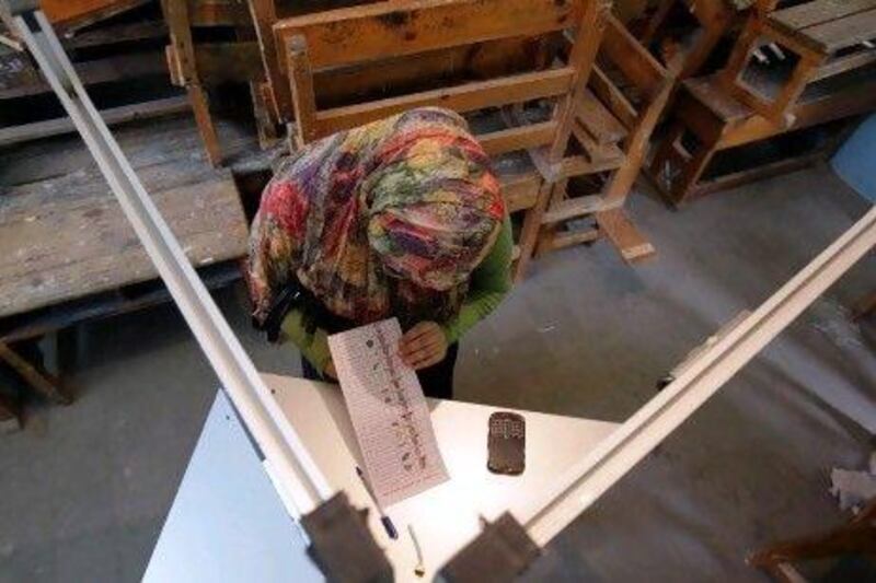An Egyptian woman ponders over her ballot paper in the country's first free presidential elections.