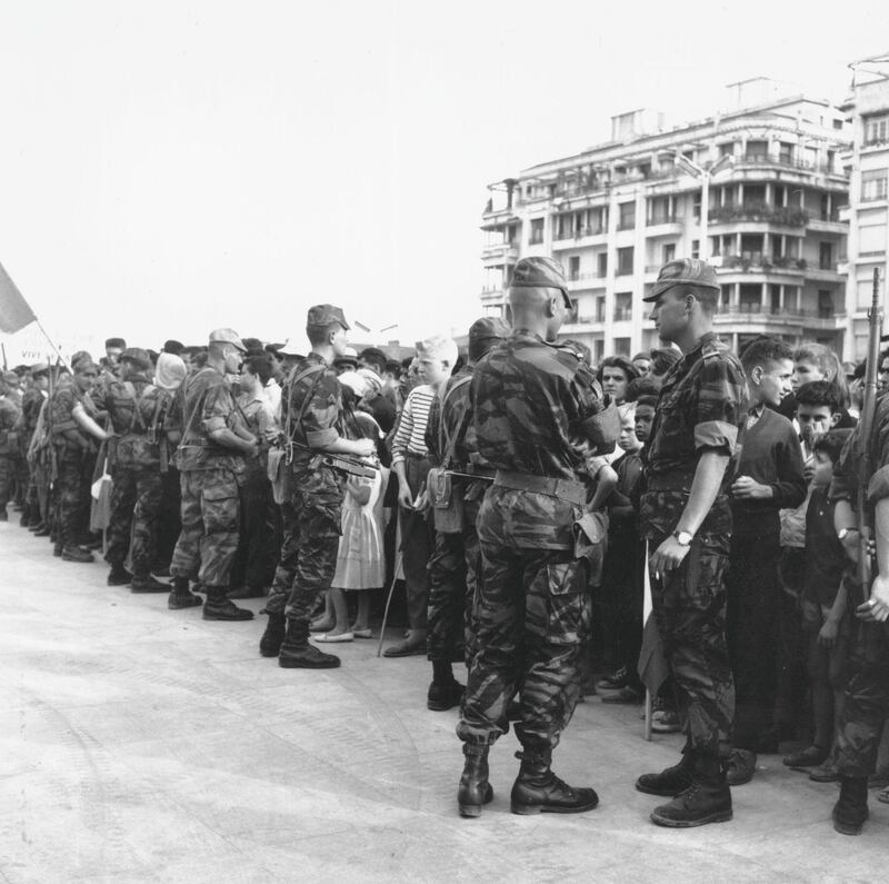 23rd May 1958:  French troops holding back crowds in front of Government House, Algiers, during the Algerian War of Independence.  (Photo by Stan Meagher/Express/Getty Images)