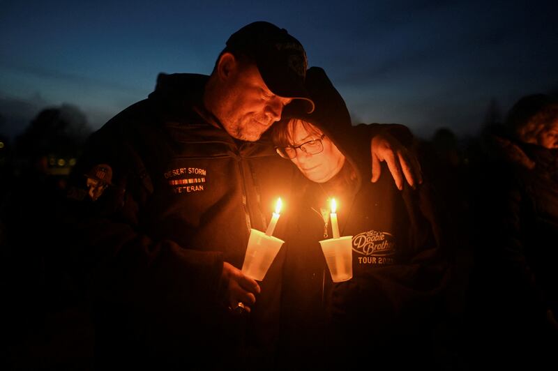 Dan and Kathy Pratt embrace each other at a vigil, after a fatal shooting at Perry High School, in Perry, Iowa. Reuters