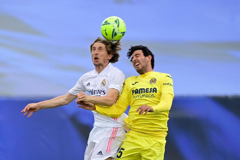 Real's Luka Modric and Daniel Parejo of Villarreal challenge for a header. AFP