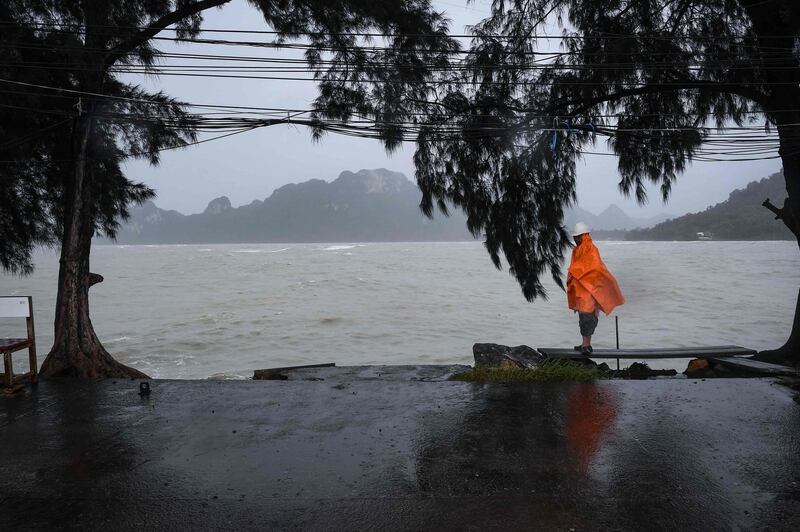 A man guards an empty pier after tour operators were forced to suspend boats to tourist islands due to tropical storm Pabuk, in the southern Thai province of Surat Thani.  AFP
