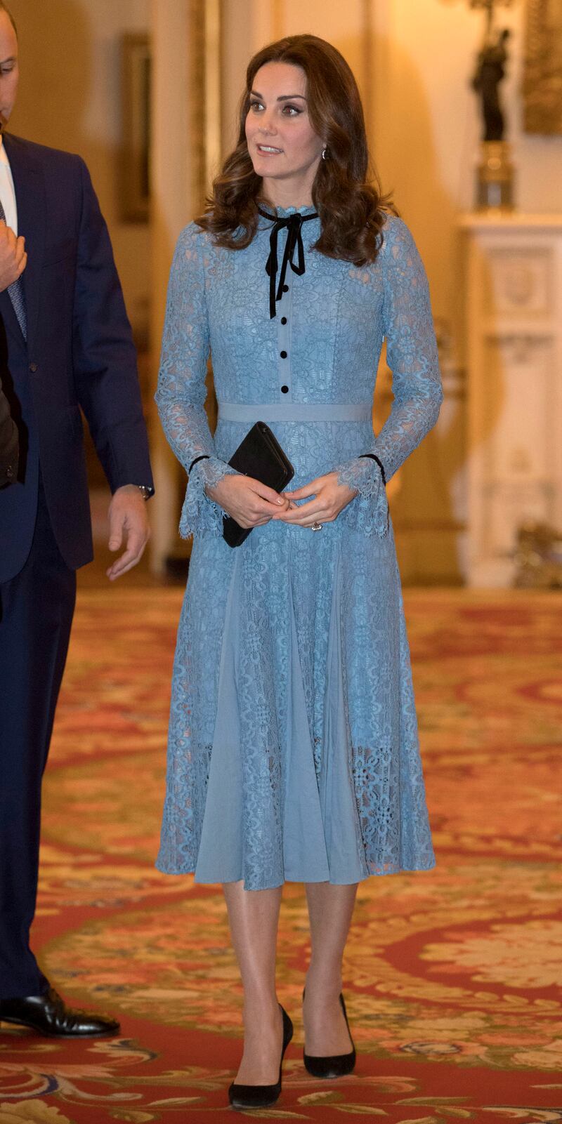 Catherine, Duchess of Cambridge, in blue lace Temperley London, attends a World Mental Health Day reception at Buckingham Palace in London on October 10, 2017. Getty Images