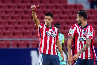 epa08702013 Atletico Madrid's striker Luis Suarez (L) celebrates after scoring the 5-0 goal during the Spanish Laliga soccer match between Atletico Madrid and Granada held at Wanda Metropolitano Stadium, in Madrid, central Spain, 27 September 2020. EPA/RODRIGO JIMENEZ