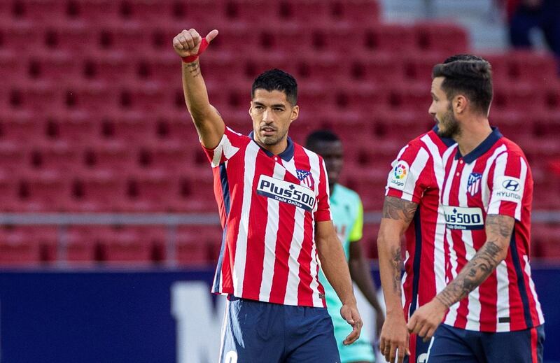 epa08702013 Atletico Madrid's striker Luis Suarez (L) celebrates after scoring the 5-0 goal during the Spanish Laliga soccer match between Atletico Madrid and Granada held at Wanda Metropolitano Stadium, in Madrid, central Spain, 27 September 2020.  EPA/RODRIGO JIMENEZ