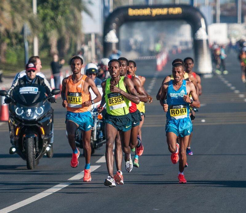 2015 Dubai Marathon winner Lemi Berhanu Hayle, left, shown trailing Lelisa Desisa at the three-quarters mark of Friday's race. Stephen Hindley / AP