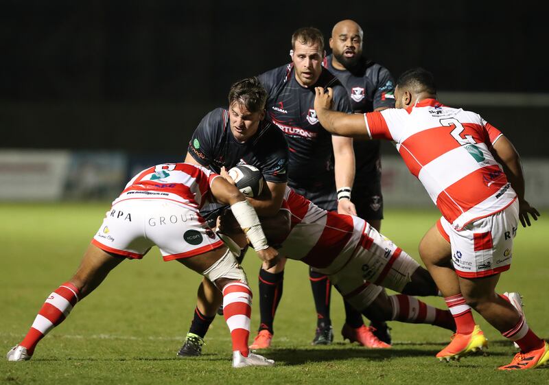 Dubai Exiles' Shane Weweje is tackled in the game against the Dubai Tigers.