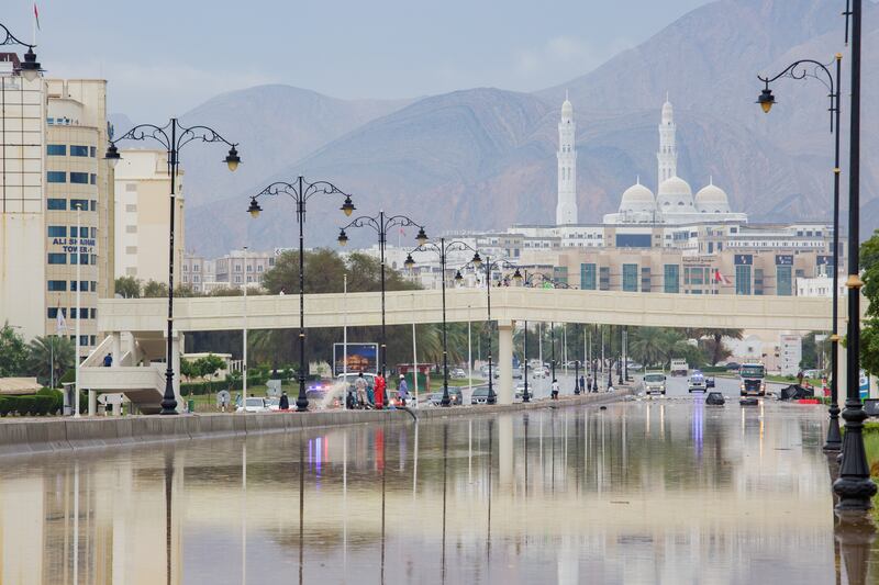 Police temporarily block Sultan Qaboos Highway to allow municipal workers to pump water from the road.