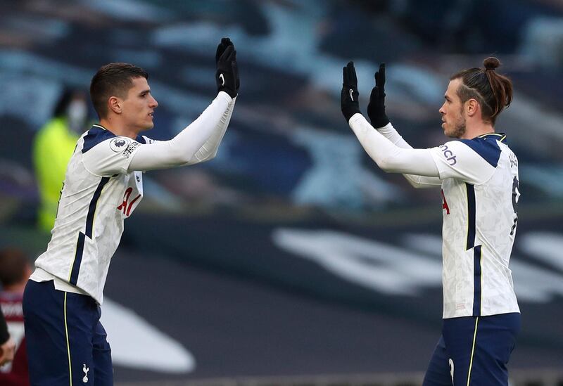 Tottenham Hotspur's Erik Lamela (left) greets Bale as he leaves the field. PA