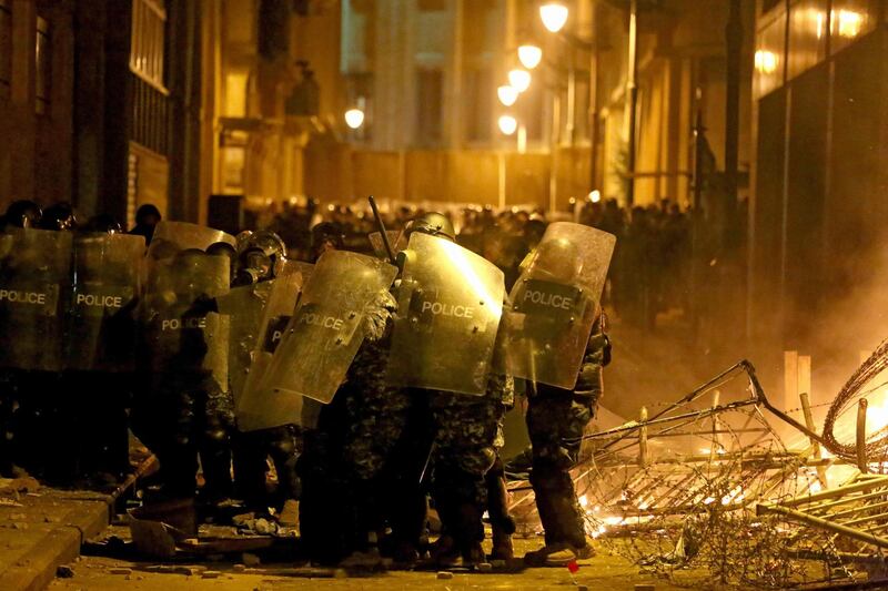 Riot police forces block a road leading to the parliament during clashes with anti-government protesters. AFP