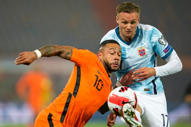 Norway's Stian Gregersen, right, and Netherlands' Memphis Depay collide as they compete for the ball. AP Photo