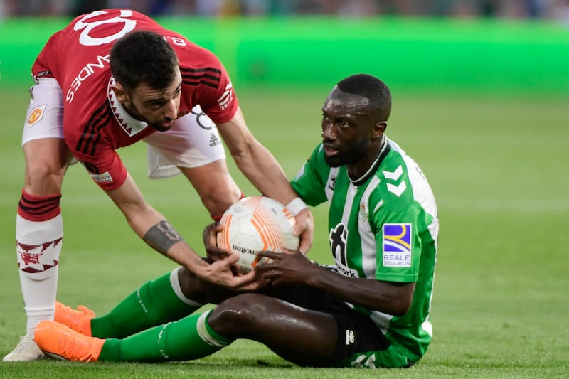 United midfielder Bruno Fernandes (L) tries to take the ball off Real Betis defender Youssouf Sabaly. AFP