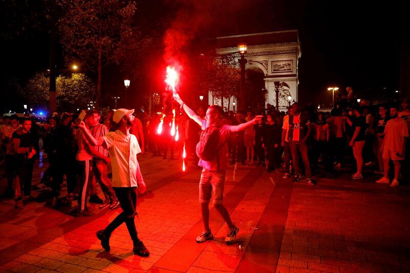 Paris Saint-Germain supporters celebrate their team's 3-0 win over RB Leipzig on the Champs-Elysees. AFP
