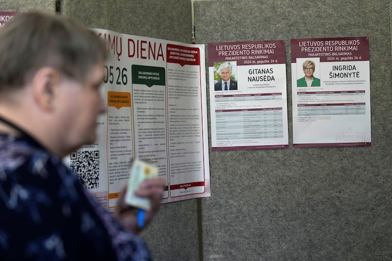 A woman waits during the second round of the presidential election in Pasvalys, Lithuania. Reuters