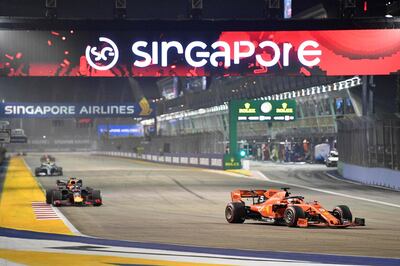 Ferrari's German driver Sebastian Vettel (R) takes part in the Formula One Singapore Grand Prix night race at the Marina Bay Street Circuit in Singapore on September 22, 2019. / AFP / Mladen ANTONOV
