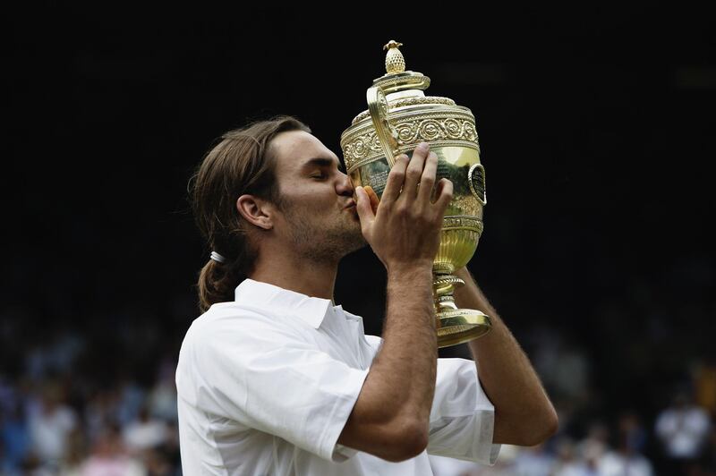 LONDON - JULY 6:  Roger Federer of Switzerland kisses the trophy after his victory over Mark Philippoussis of Australia in the Men's Singles Final during the final day of the Wimbledon Lawn Tennis Championships held on July 6, 2003 at the All England Lawn Tennis and Croquet Club, in Wimbledon, London. (Photo by Alex Livesey/Getty Images)