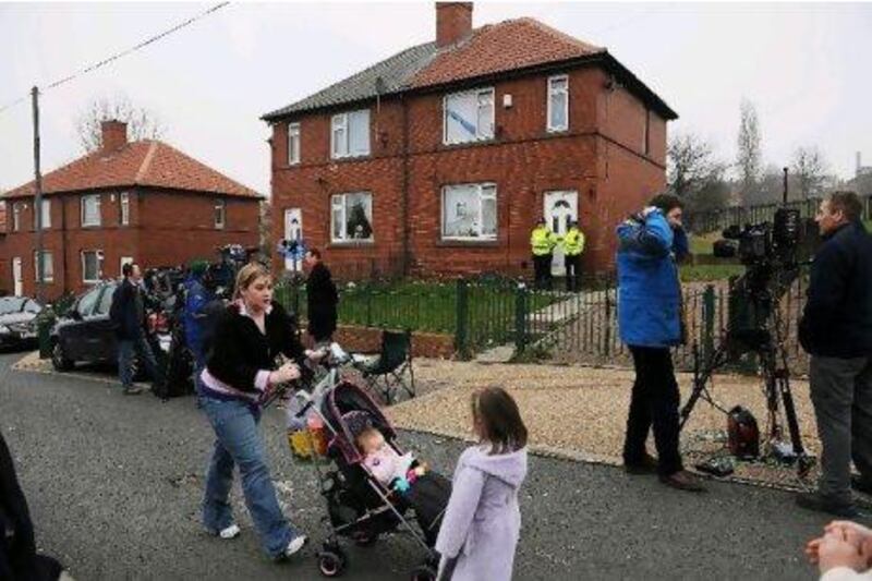 Police officers guard the home of Shannon Matthews, 9, from Moorside Road, Dewsbury, West Yorkshire, who was found alive 24 days after she disappeared on her way home from school in 2008. PA Archive