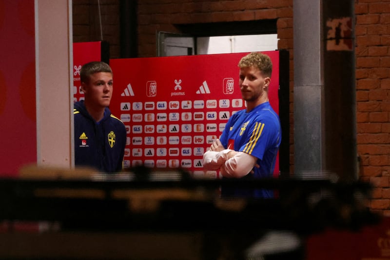 Swedish players Samuel Gustafson and Emil Holm wait to leave the stadium. Reuters