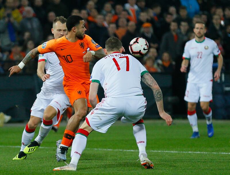 Depay and Belarus' Mikhail Sivakov challenge for the ball. AP Photo