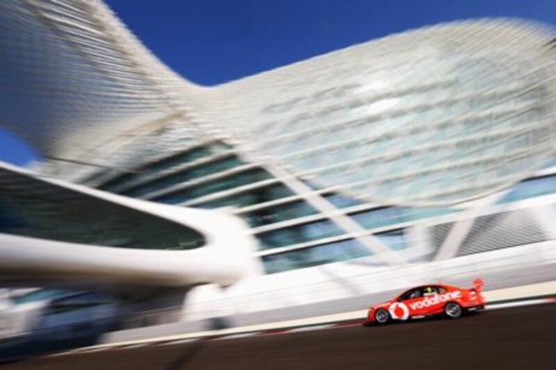 Jamie Whincup drives his Team Vodafone Holden Commodore past the distinctive sights at Yas Marina Circuit during V8 Supercars qualifying
