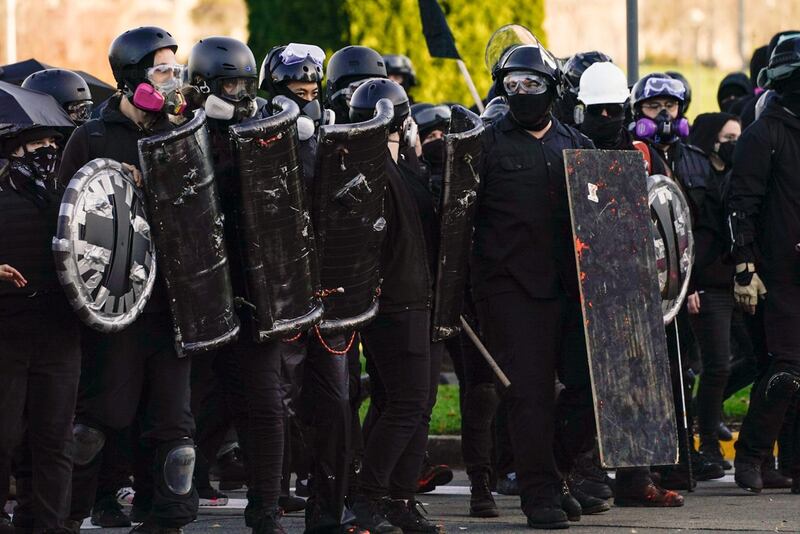 Anti-fascist protesters watch supporters of President Donald Trump during political clashes in Olympia, Washington. AFP