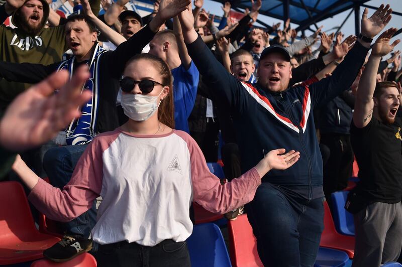 Fans of FC Dinamo-Minsk show support for their team. AFP