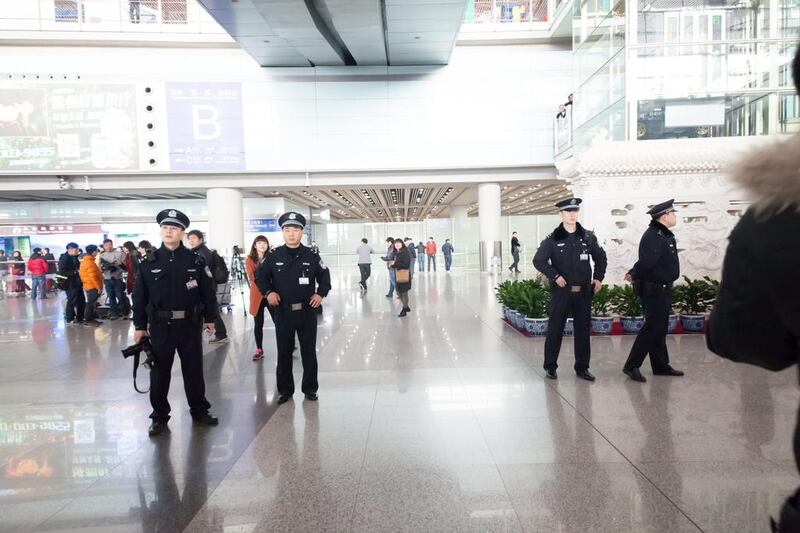 Police patrol Beijing International Airport. Xiao Lu Chu / Getty Images