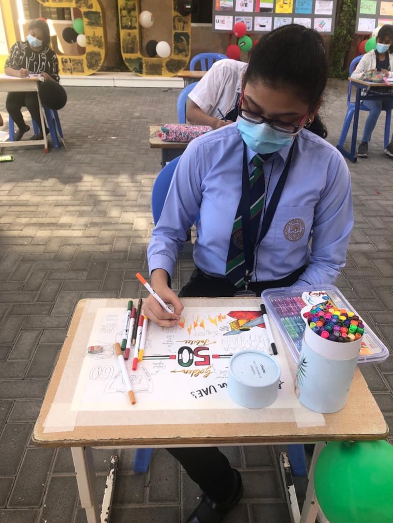 A pupil creates artwork to celebrate the UAE's 50th National Day.