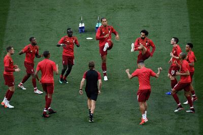 Liverpool's players warm up prior to the start of the UEFA Champions League final football match between Liverpool and Tottenham Hotspur at the Wanda Metropolitan Stadium in Madrid on June 1, 2019. / AFP / PIERRE-PHILIPPE MARCOU
