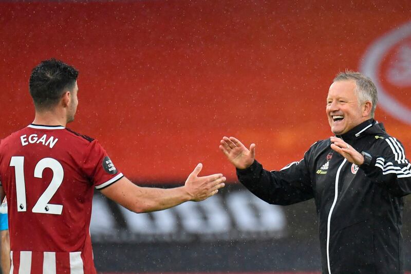 Sheffield United's John Egan is congratulated by manager Chris Wilder. AFP