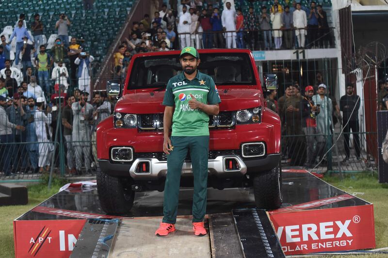 Babar Azam poses with car he won for being the player of the series. AFP