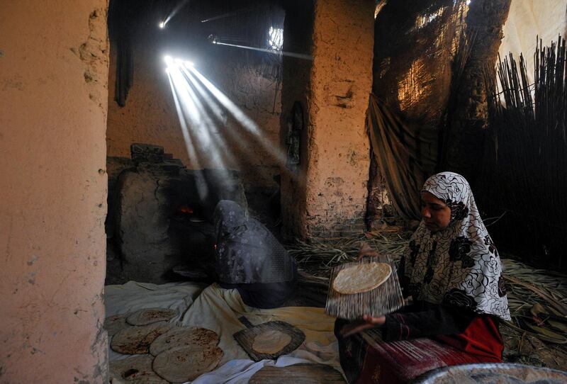 A woman bakes bread for sale to incoming tourists to improve her living conditions in a village at Saqqara, near Giza, Egypt, April 27, 2021. Picture taken April 27, 2021. REUTERS/Shokry Hussien