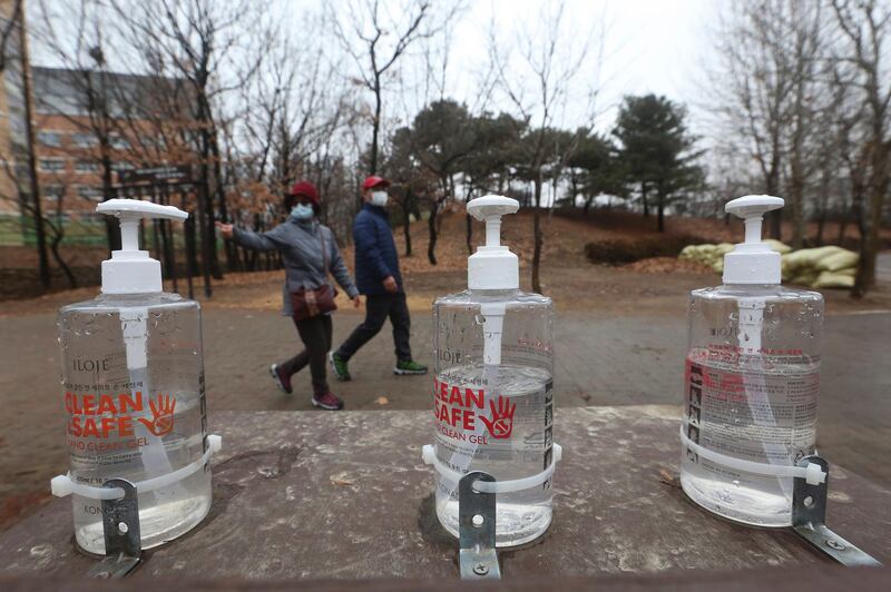 Bottles of hand sanitizer are displayed for use at a park in Goyang, South Korea, Friday, Jan. 22, 2021. South Korea is reporting its smallest daily increase in coronavirus infections in two months as officials express cautious hope that the country is beginning to wiggle out from its worst wave of the pandemic. (AP Photo/Ahn Young-joon)