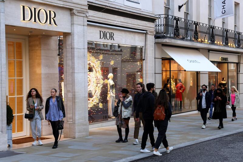 Pedestrians walk past a Dior store on New Bond Street in London. Reuters