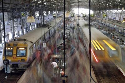 Commuters board suburban trains during the evening rush hour at Churchgate railway station in Mumbai. Reuters