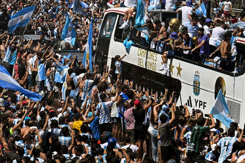 Argentina fans celebrate their World Cup-winning squad as they parade through the captial. AFP