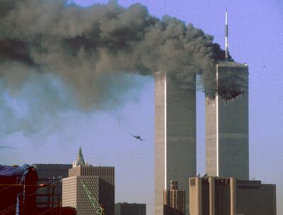 Hijacked United Airlines Flight 175 (L) flies toward the World Trade Center twin towers shortly before slamming into the south tower (L) as the north tower burns following an earlier attack by a hijacked airliner in New York City September 11, 2001. The stunning aerial assaults on the huge commercial complex where more than 40,000 people worked on an ordinary day were part of a coordinated attack aimed at the nation's financial heart. They destroyed one of America's most dramatic symbols of power and financial strength and left New York reeling. FR05070027 SECOND OF SEVEN PHOTOGRAPHS REUTERS/Sean Adair  SV