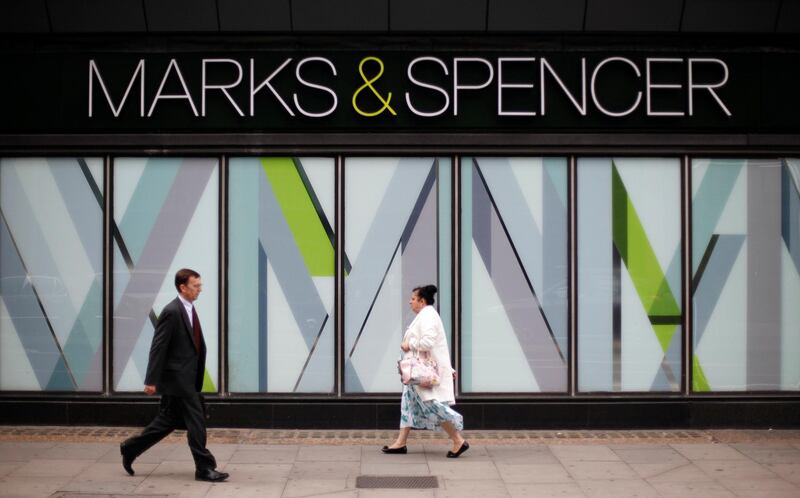 FILE PHOTO: Pedestrians walk past an Marks and Spencer shop in northwest London, Britain July 8, 2014.  REUTERS/Suzanne Plunkett/File Photo