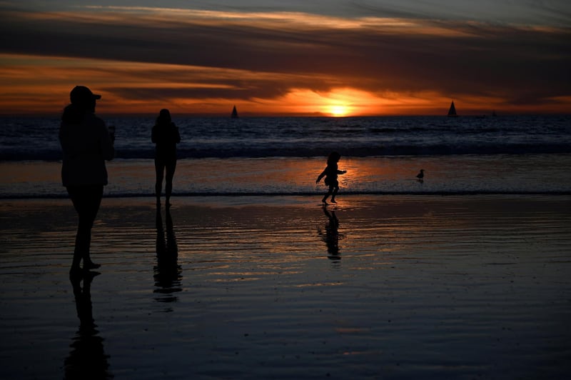 People visit the beach a day before renewed restrictions due to a surge of Covid-19 cases in Los Angeles, California, US. Reuters