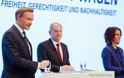 Germany's Free Democratic Party leader Christian Lindner (L) next to prospective Chancellor Olaf Scholz (C) and the co-leader of the Greens Annalena Baerbock. The FDP will have the keys to the German Treasury under the pact. AFP